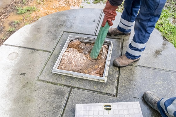 cesspool pumping involves removing accumulated sludge and liquid waste from a cesspool using a specialized pumping truck